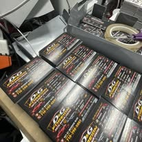 Printed promotional cards on the production table.