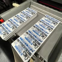 Business-card sheets laid out during production.