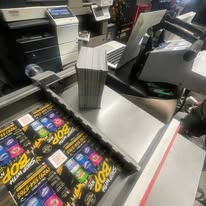 Stacks of printed pieces and card sheets in the workshop.